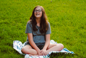 meredith pritchard girl sitting on a blanket in the grass