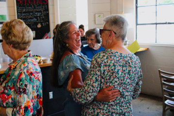 meredith pritchard two women hugging at a party