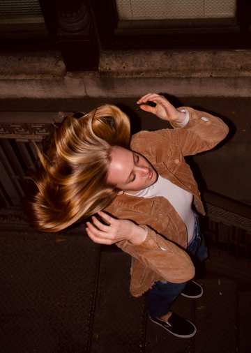 meredith pritchard girl flipping her hair on the stairs below